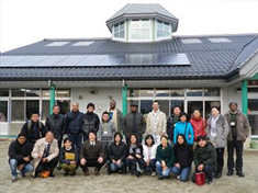 In front of solar panels installed at a nursery rooftop overcoming regulatory difficulties (Kanae Mitsuba Nursery)